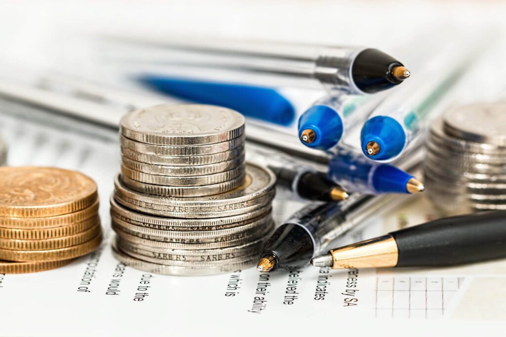 quickbooks payroll-coins on pens and paper