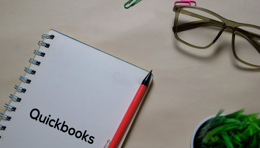 Quickbooks write on a book isolated on Office Desk